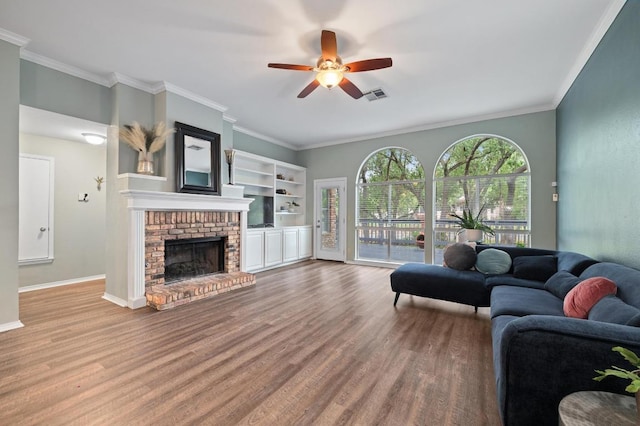 8007 Weldon Springs Ct, Austin, TX 78726 - living area with wood finished floors, a ceiling fan, a fireplace, and crown molding