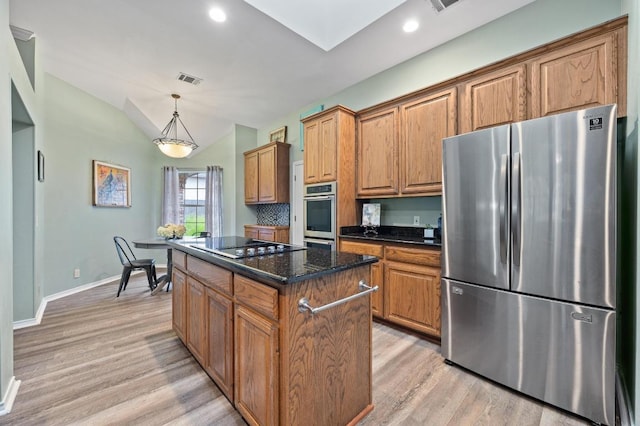 8007 Weldon Springs Ct, Austin, TX 78726 - kitchen featuring stainless steel appliances, light wood finished floors, a kitchen island, decorative light fixtures, and lofted ceiling
