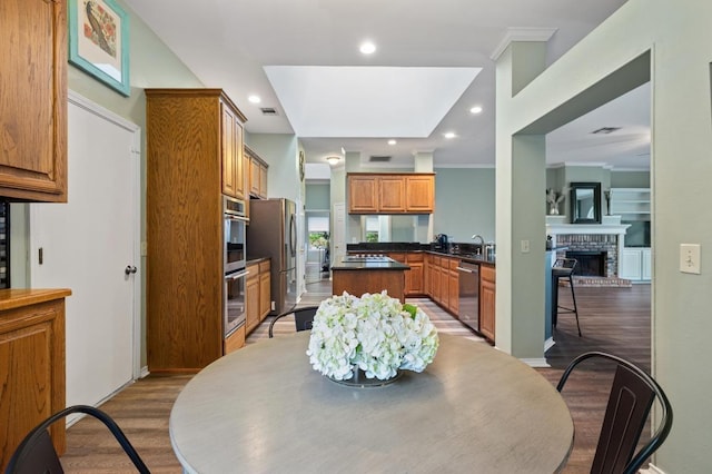 8007 Weldon Springs Ct, Austin, TX 78726 - dining space featuring wood finished floors, a fireplace, recessed lighting, and ornamental molding