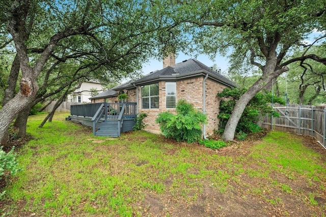 8007 Weldon Springs Ct, Austin, TX 78726 - view of property exterior featuring brick siding, a chimney, and a deck