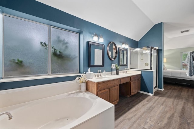 8007 Weldon Springs Ct, Austin, TX 78726 - full bathroom with wood finished floors, a garden tub, double vanity, ensuite bath, and lofted ceiling