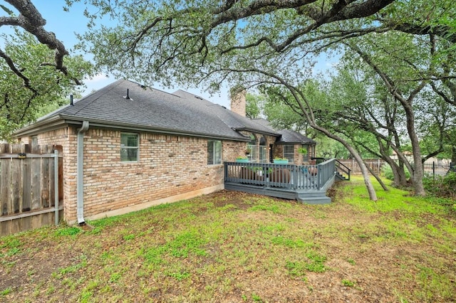 8007 Weldon Springs Ct, Austin, TX 78726 - rear view of property featuring a chimney, brick siding, a wooden deck, and a shingled roof