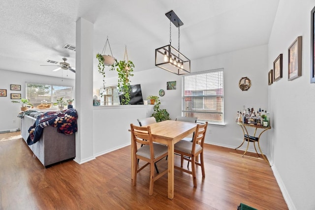 1112 Battenburg Trl, Pflugerville, TX 78660 - dining area with wood finished floors, ceiling fan, and baseboards