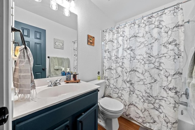 1112 Battenburg Trl, Pflugerville, TX 78660 - full bath featuring vanity, toilet, shower / bath combination with curtain, wood finished floors, and a textured wall