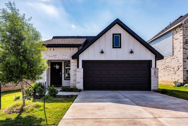185 Standing Rock Ln, Marble Falls, TX 78654 - modern farmhouse style home with board and batten siding, driveway, and an attached garage