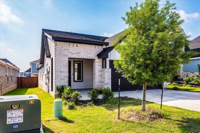185 Standing Rock Ln, Marble Falls, TX 78654 - view of front of home with stone siding, concrete driveway, a garage, and board and batten siding
