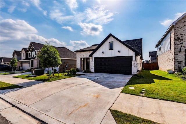 185 Standing Rock Ln, Marble Falls, TX 78654 - modern farmhouse featuring board and batten siding, concrete driveway, brick siding, an attached garage, and a residential view