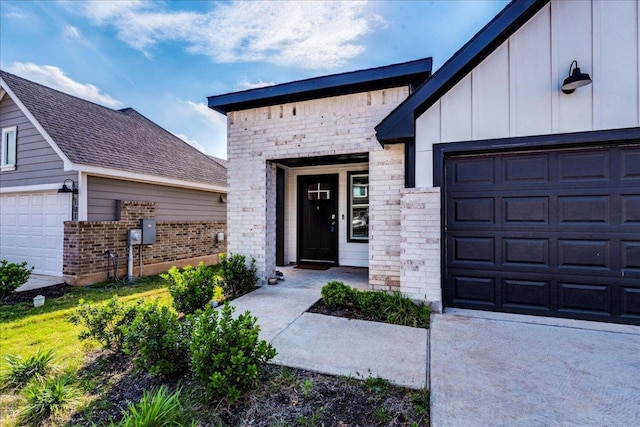 185 Standing Rock Ln, Marble Falls, TX 78654 - entrance to property featuring a garage, brick siding, board and batten siding, and concrete driveway