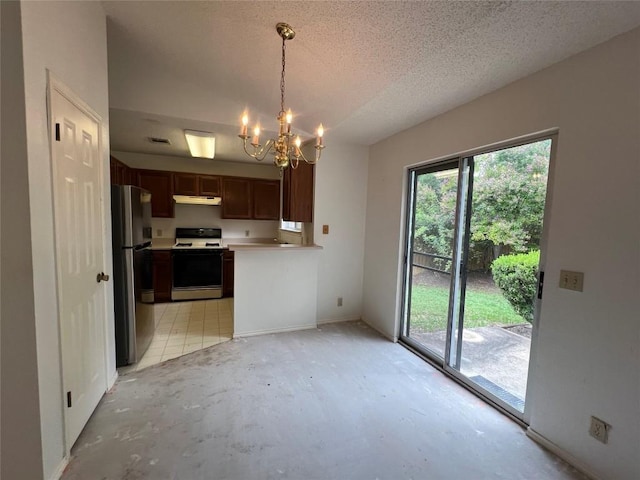 6612 Zequiel Dr, Austin, TX 78744 - kitchen with white gas range oven, freestanding refrigerator, under cabinet range hood, a chandelier, and light countertops
