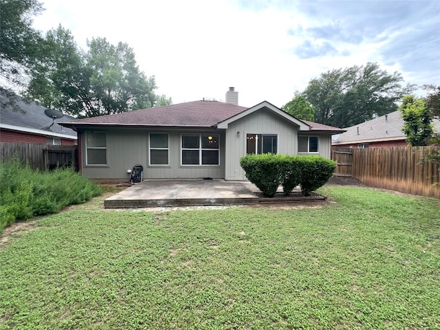 6612 Zequiel Dr, Austin, TX 78744 - back of house with a patio area, a chimney, and a shingled roof