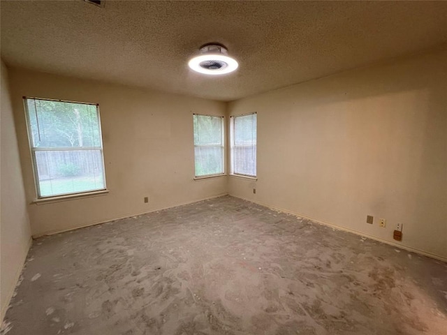 6612 Zequiel Dr, Austin, TX 78744 - unfurnished room featuring plenty of natural light and a textured ceiling