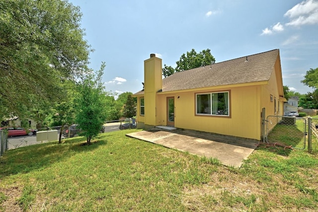5000 Acorn Grove Ct, Austin, TX 78744 - rear view of house featuring a chimney, a gate, a patio, and a shingled roof