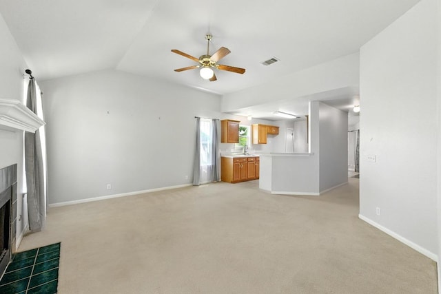 5000 Acorn Grove Ct, Austin, TX 78744 - unfurnished living room with a tile fireplace, a ceiling fan, a sink, light colored carpet, and vaulted ceiling