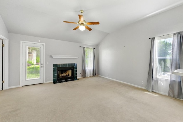 5000 Acorn Grove Ct, Austin, TX 78744 - unfurnished living room featuring a ceiling fan, lofted ceiling, plenty of natural light, a tile fireplace, and carpet floors