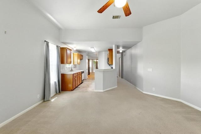 5000 Acorn Grove Ct, Austin, TX 78744 - kitchen with light countertops, open floor plan, light colored carpet, and dishwasher