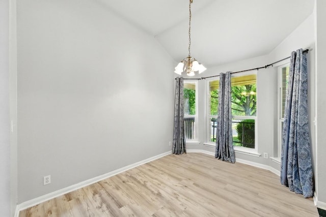 5000 Acorn Grove Ct, Austin, TX 78744 - unfurnished dining area featuring a chandelier, wood finished floors, baseboards, and lofted ceiling
