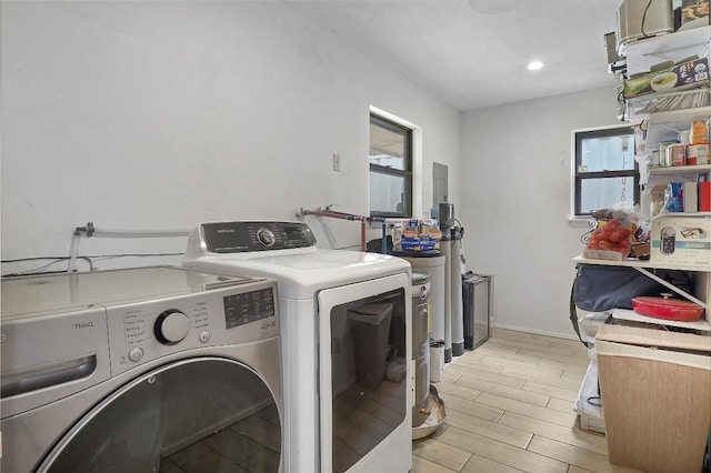 1313 Oakridge Dr, Blanco, TX 78606 - laundry area featuring washing machine and clothes dryer, wood tiled floors, and recessed lighting