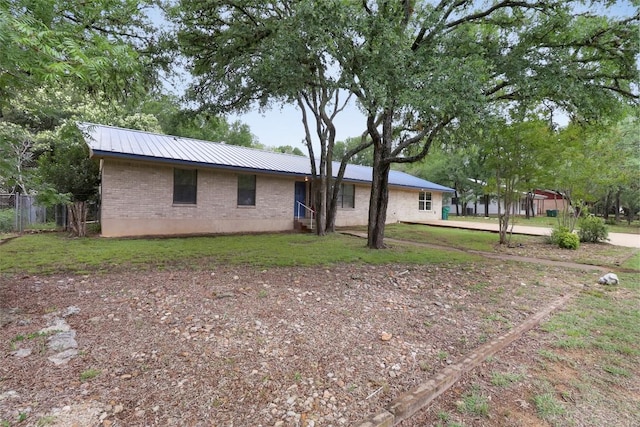 1313 Oakridge Dr, Blanco, TX 78606 - view of front facade with a metal roof and brick siding