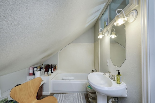 3780 Fm 972, Georgetown, TX 78673 - full bathroom featuring lofted ceiling, a textured ceiling, and a garden tub