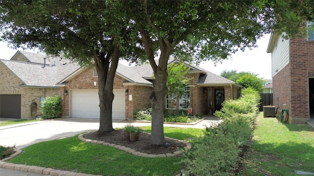 2721 Saddle Blanket Pl, Leander, TX 78641 - view of front of property with brick siding, driveway, a shingled roof, a garage, and a front yard