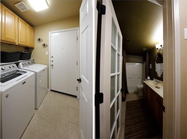 2721 Saddle Blanket Pl, Leander, TX 78641 - laundry room featuring washer and clothes dryer, cabinet space, and light tile patterned floors