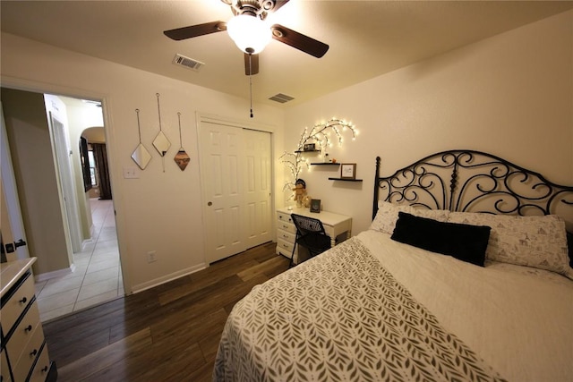 2721 Saddle Blanket Pl, Leander, TX 78641 - bedroom featuring wood finished floors, arched walkways, ceiling fan, and a closet