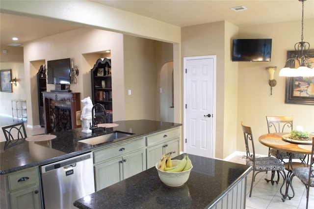 2721 Saddle Blanket Pl, Leander, TX 78641 - kitchen with dishwasher, arched walkways, an island with sink, light tile patterned floors, and pendant lighting