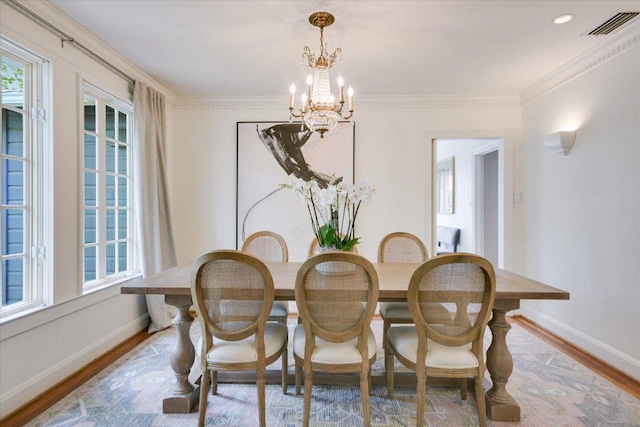 2509 Spring Ln, Austin, TX 78703 - dining space featuring wood finished floors, a chandelier, baseboards, and ornamental molding
