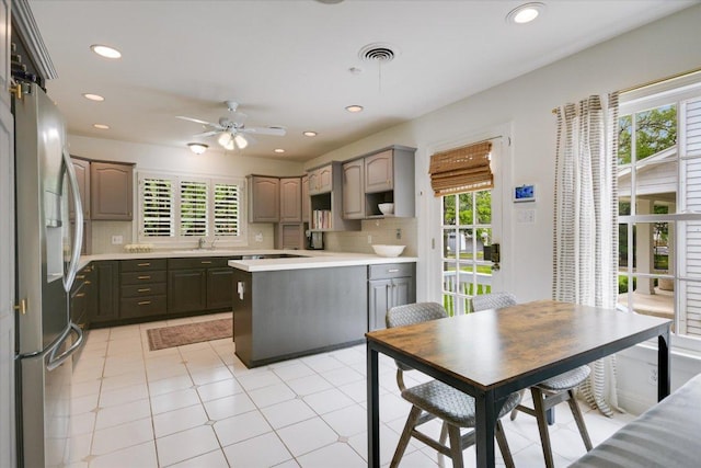 2509 Spring Ln, Austin, TX 78703 - kitchen with stainless steel refrigerator with ice dispenser, healthy amount of natural light, a ceiling fan, light countertops, and recessed lighting
