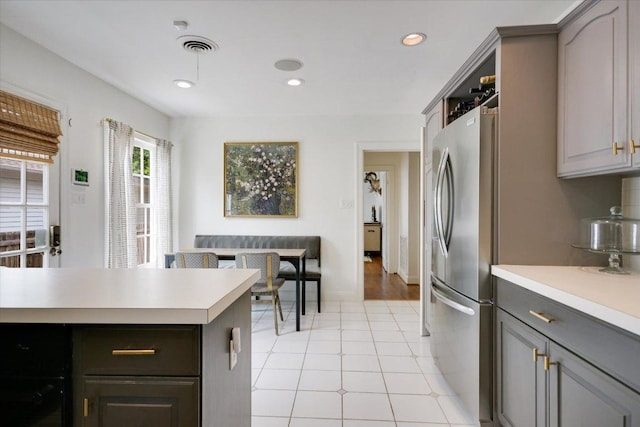 2509 Spring Ln, Austin, TX 78703 - kitchen featuring freestanding refrigerator, light countertops, gray cabinetry, and recessed lighting