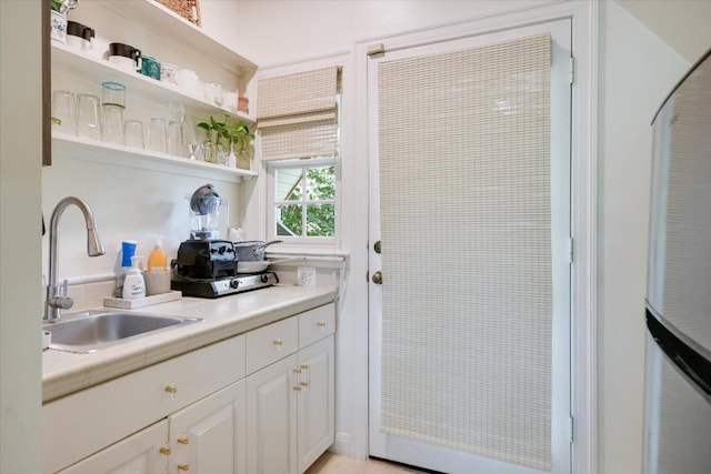 2509 Spring Ln, Austin, TX 78703 - kitchen with open shelves, white cabinets, light countertops, and a heating unit