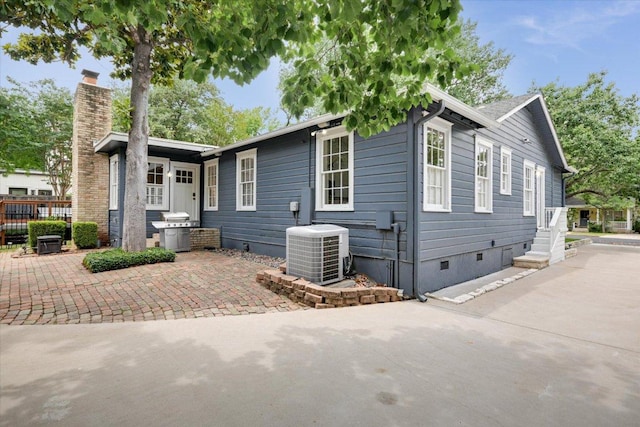 2509 Spring Ln, Austin, TX 78703 - view of front of property with central AC unit, crawl space, a chimney, and a patio area