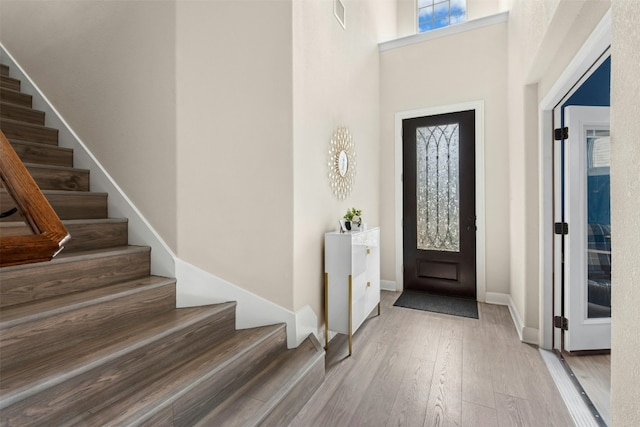 21105 Huckabee Bnd, Pflugerville, TX 78660 - entrance foyer featuring stairway, hardwood / wood-style flooring, baseboards, and a towering ceiling