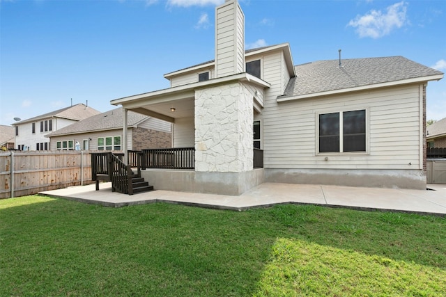 21105 Huckabee Bnd, Pflugerville, TX 78660 - rear view of house featuring a chimney, a patio area, roof with shingles, and stone siding