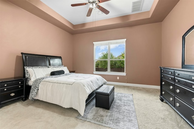 21105 Huckabee Bnd, Pflugerville, TX 78660 - bedroom featuring light carpet, a raised ceiling, baseboards, and a ceiling fan