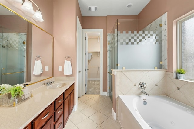 21105 Huckabee Bnd, Pflugerville, TX 78660 - full bathroom featuring a stall shower, vanity, a jetted tub, tile patterned flooring, and a walk in closet