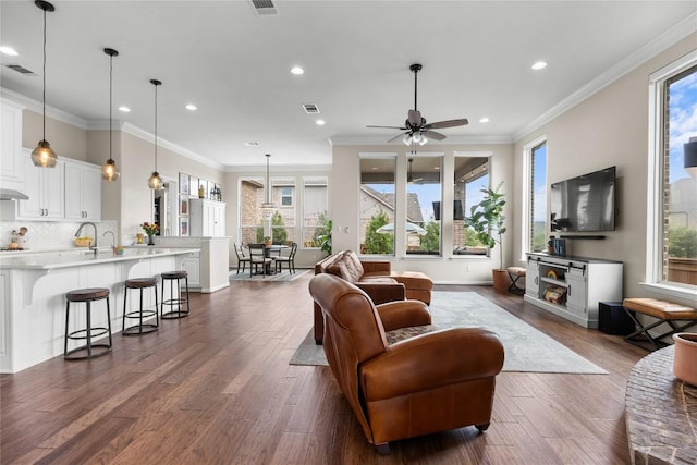 562 Stone River Dr, Austin, TX 78737 - living room featuring dark wood-style floors, recessed lighting, crown molding, ceiling fan, and baseboards