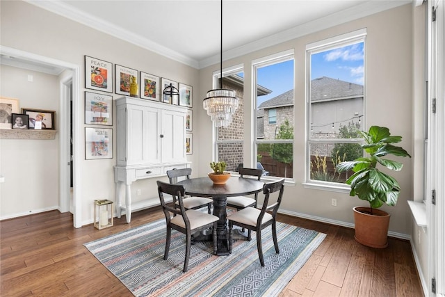 562 Stone River Dr, Austin, TX 78737 - dining space featuring healthy amount of natural light, a chandelier, hardwood / wood-style flooring, baseboards, and ornamental molding