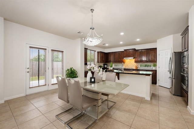 112 Bearing Cv, Austin, TX 78717 - dining area featuring light tile patterned flooring, a chandelier, recessed lighting, and baseboards