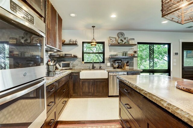 11700 Rim Rock Trl, Austin, TX 78737 - kitchen with open shelves, stainless steel appliances, plenty of natural light, decorative light fixtures, and recessed lighting