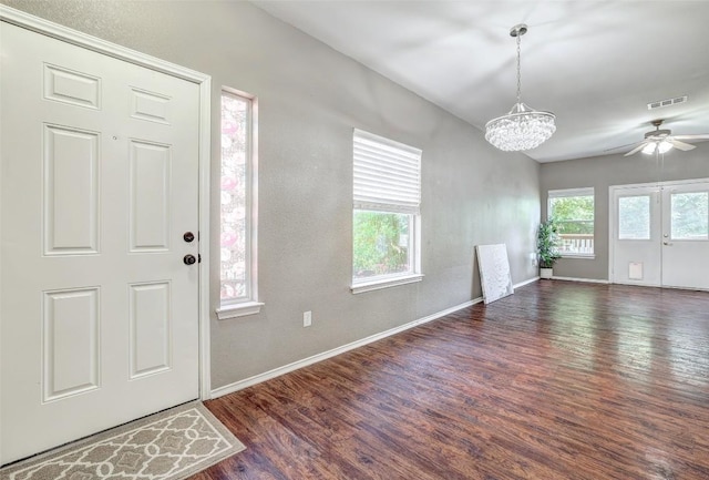 1003 E 3rd St, Georgetown, TX 78626 - entrance foyer featuring wood finished floors, baseboards, a ceiling fan, and a chandelier
