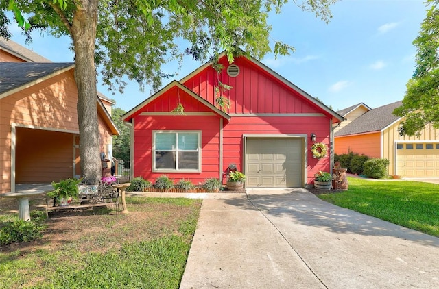 1003 E 3rd St, Georgetown, TX 78626 - view of front of home featuring board and batten siding, driveway, a garage, and a front yard