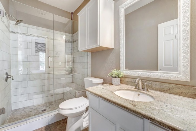 1003 E 3rd St, Georgetown, TX 78626 - bathroom with a stall shower, toilet, and vanity