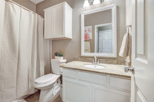 1003 E 3rd St, Georgetown, TX 78626 - full bath with toilet, vanity, a textured wall, tile patterned flooring, and a shower with shower curtain
