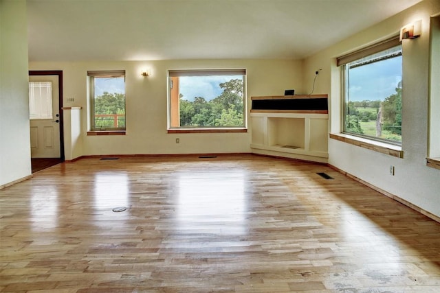 123 Konahuanui Ln, Bastrop, TX 78602 - unfurnished living room with wood finished floors and baseboards
