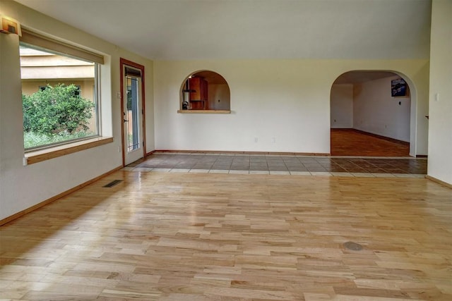 123 Konahuanui Ln, Bastrop, TX 78602 - unfurnished room featuring wood finished floors, baseboards, and arched walkways