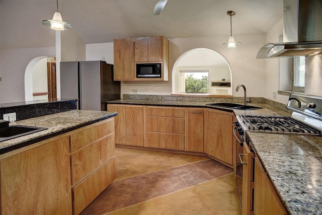123 Konahuanui Ln, Bastrop, TX 78602 - kitchen featuring stainless steel appliances, a sink, wall chimney range hood, arched walkways, and hanging light fixtures