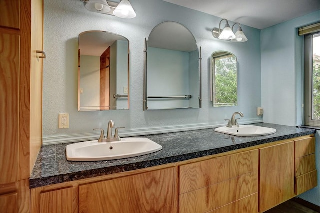 123 Konahuanui Ln, Bastrop, TX 78602 - bathroom featuring double vanity and a textured wall