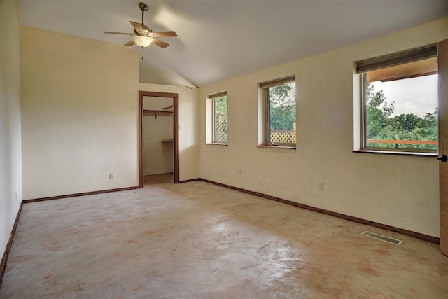 123 Konahuanui Ln, Bastrop, TX 78602 - unfurnished bedroom featuring vaulted ceiling, baseboards, a closet, concrete flooring, and ceiling fan