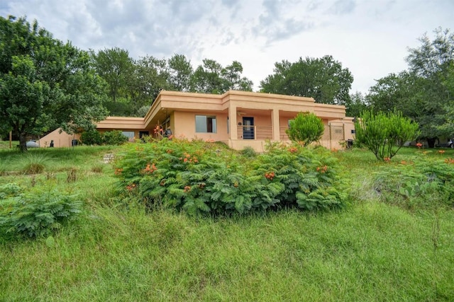 123 Konahuanui Ln, Bastrop, TX 78602 - rear view of house with stucco siding